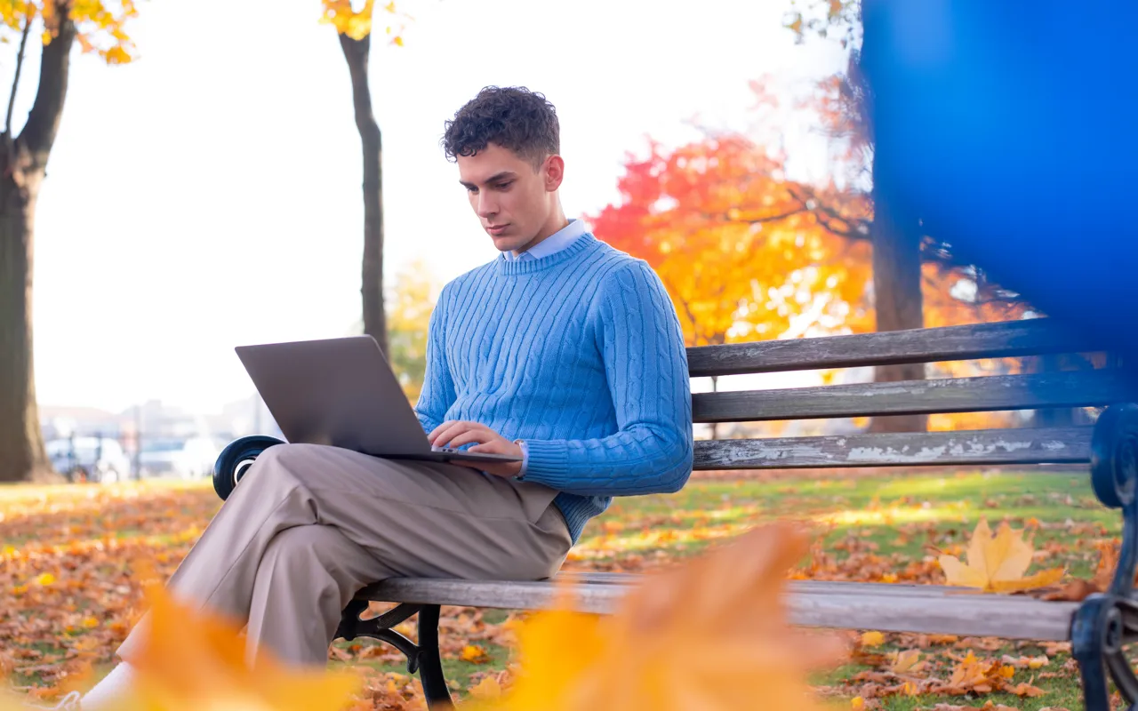 Person researching HPV vaccine prices online in London park