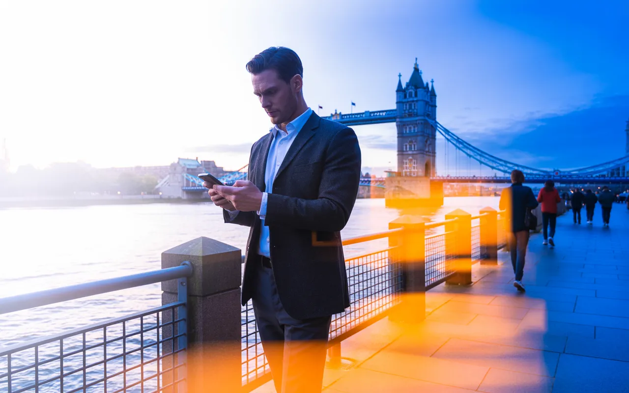 Man reviewing HPV vaccine investment costs by Thames riverside London